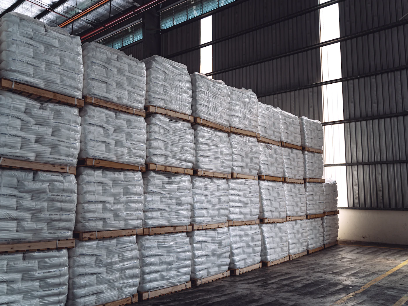 Warehouse stacked with sacks of chemicals on pallets